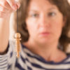 Woman using pendulum-Healing Energy Services